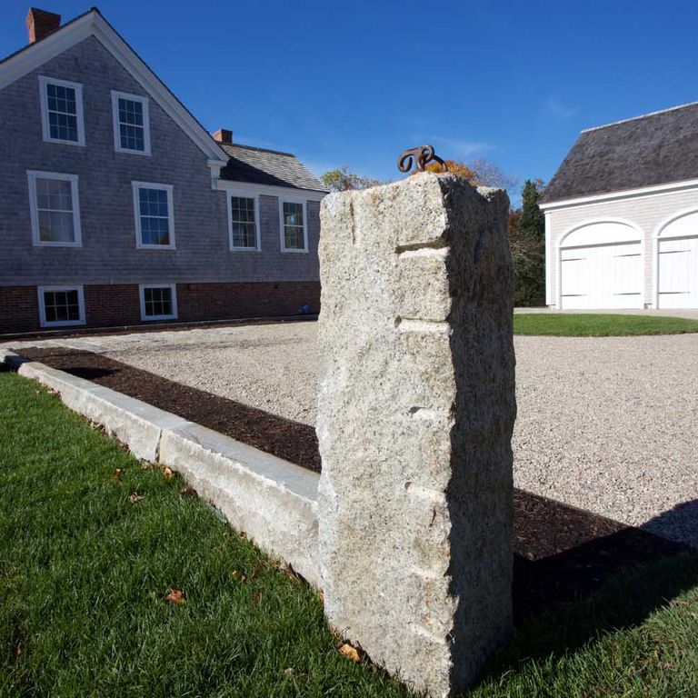 Application image for Reclaimed First Generation Curbstone - Posts. The image shows this product being used in a posts application. The dominant color shown is gray. The color mix creates a cool feeling.