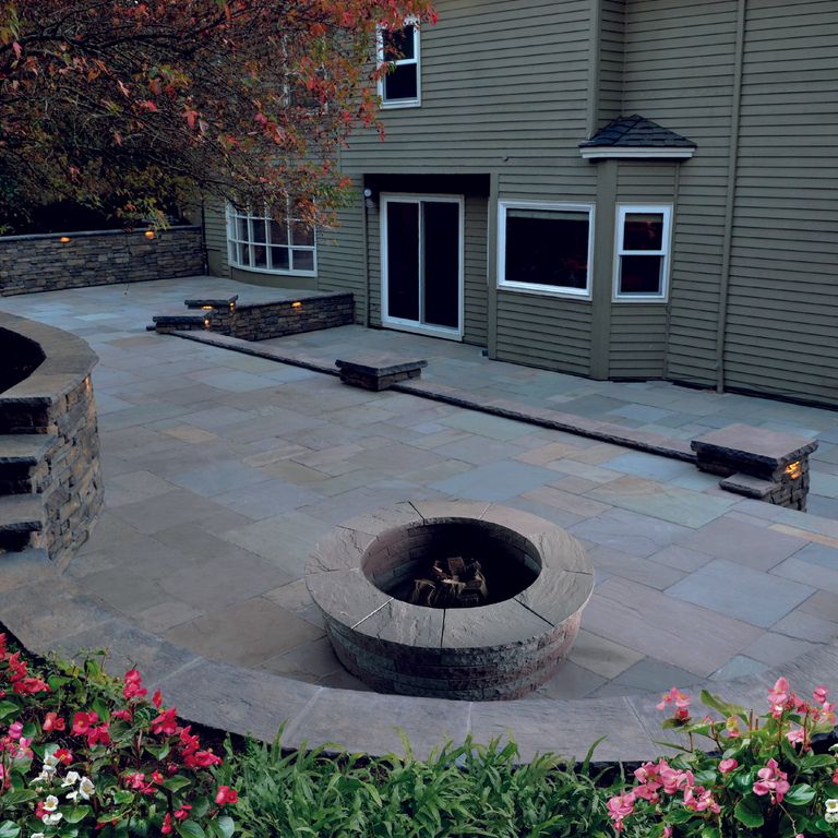 Feature image for Lakeland Sandstone - Pavers. The image shows this product being used in a patio pavers application. The surface finish shown is natural cleft. Dominant colors shown are blue and gray; with pink and tan secondaries. Exhibits 