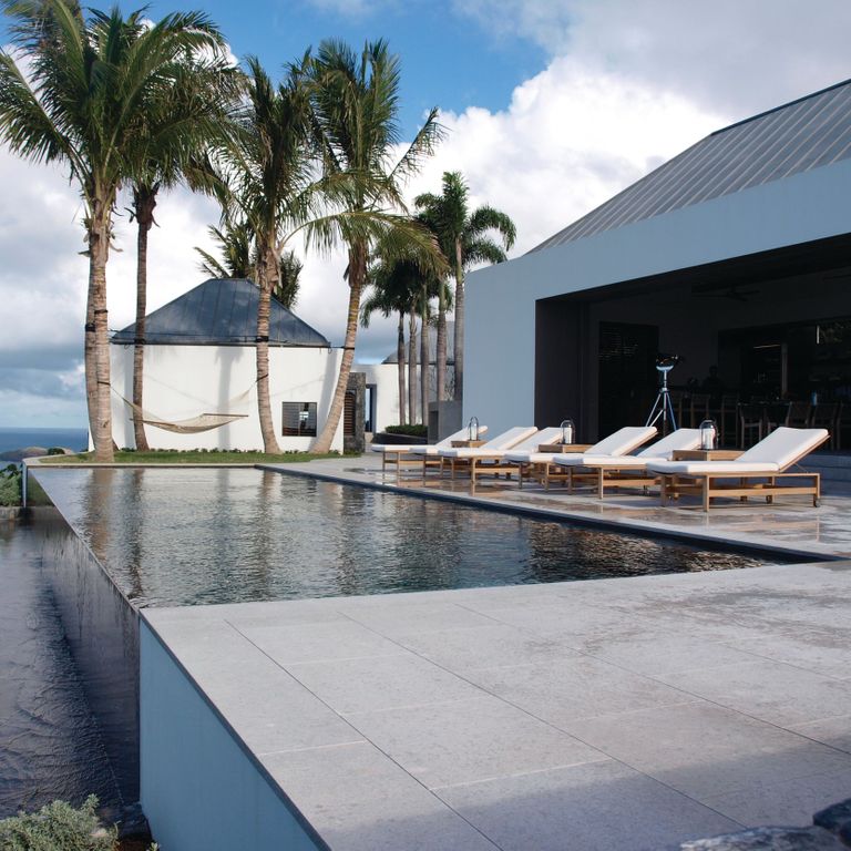Feature image for Classimo Sky Limestone - Pool Deck. The image shows this product being used in a pool deck pavers application. The surface finish shown is sand blasted. The dominant color shown is gray; with beige, blue and white secondaries. The color mix creates a cool feeling.