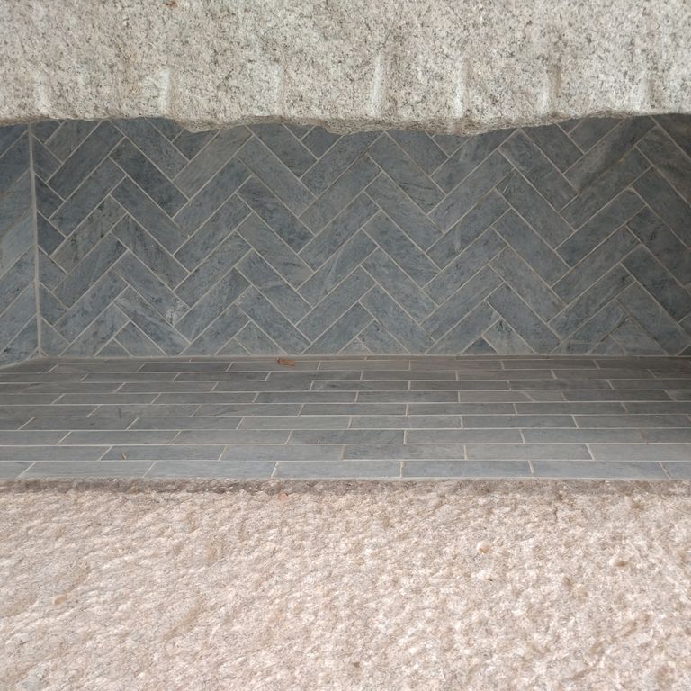 Application image for Mariana Soapstone™ Firebrick. The image shows this product being used in a firebrick application. The surface finish shown is honed. The dominant color shown is gray; with a purple secondary. The color mix creates a cool feeling. Regular color pattern.