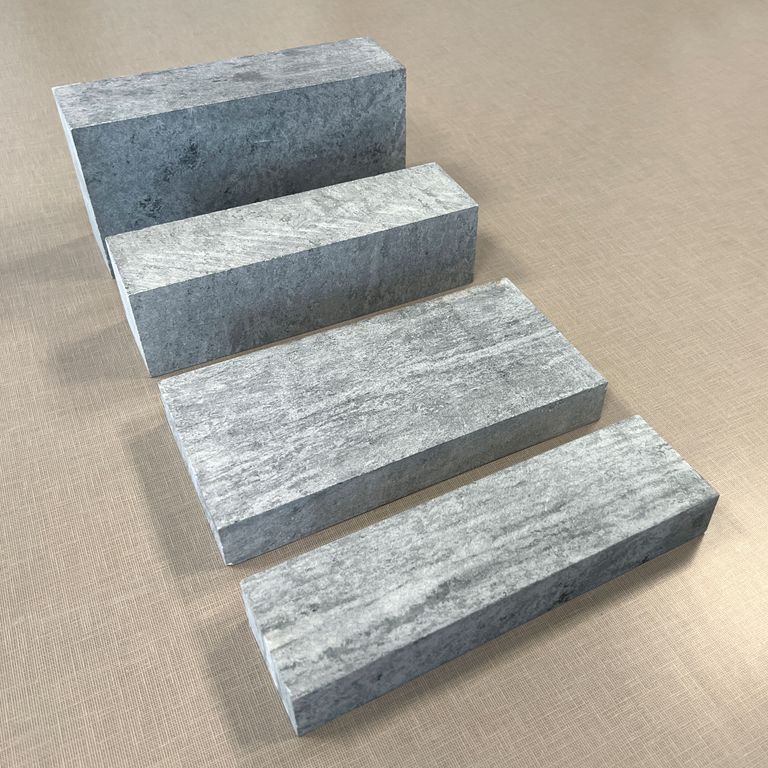 Application image for Soapstone - Curators Firebrick. The image shows this product being used in a firebrick application. The surface finish shown is honed. The dominant color shown is gray. The color mix creates a cool feeling.