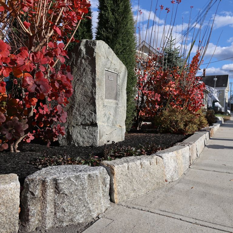 Feature image for Granite - Reclaimed Block - Edging. The image shows this product being used in a landscape curbing & edging application. The dominant color shown is gray.