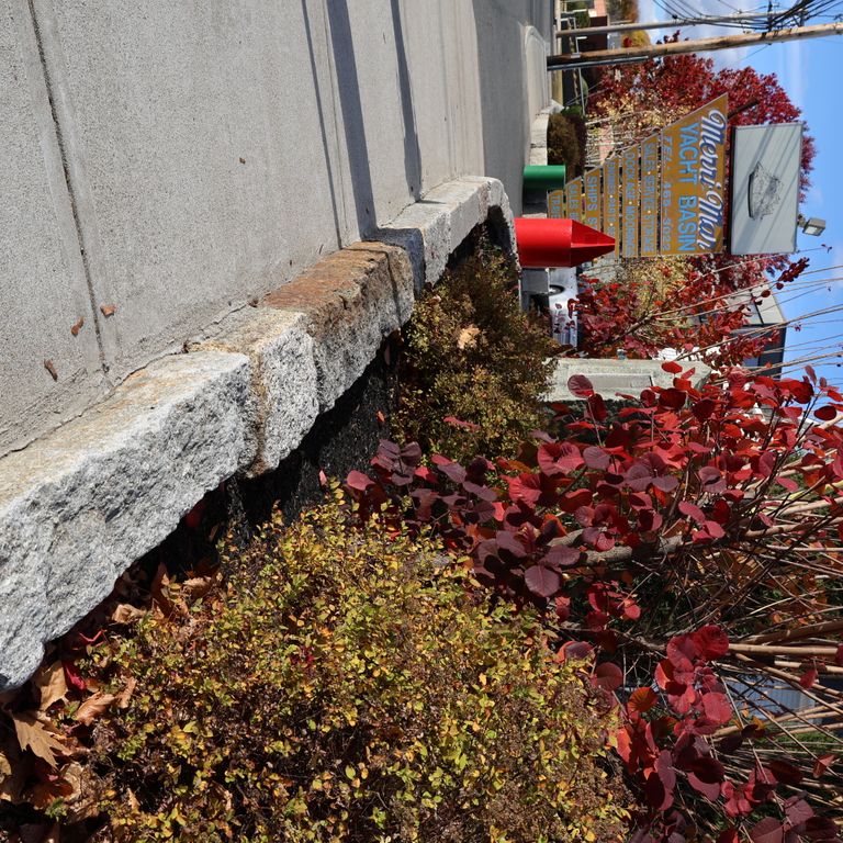 Application image for Granite - Reclaimed Block - Edging. The image shows this product being used in a landscape curbing & edging application. The dominant color shown is gray.