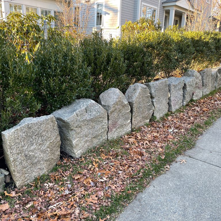 Application image for Granite - Reclaimed Block - Edging. The image shows this product being used in a landscape curbing & edging application. The surface finish shown is . The dominant color shown is gray; with a white secondary. The color mix creates a cool feeling.