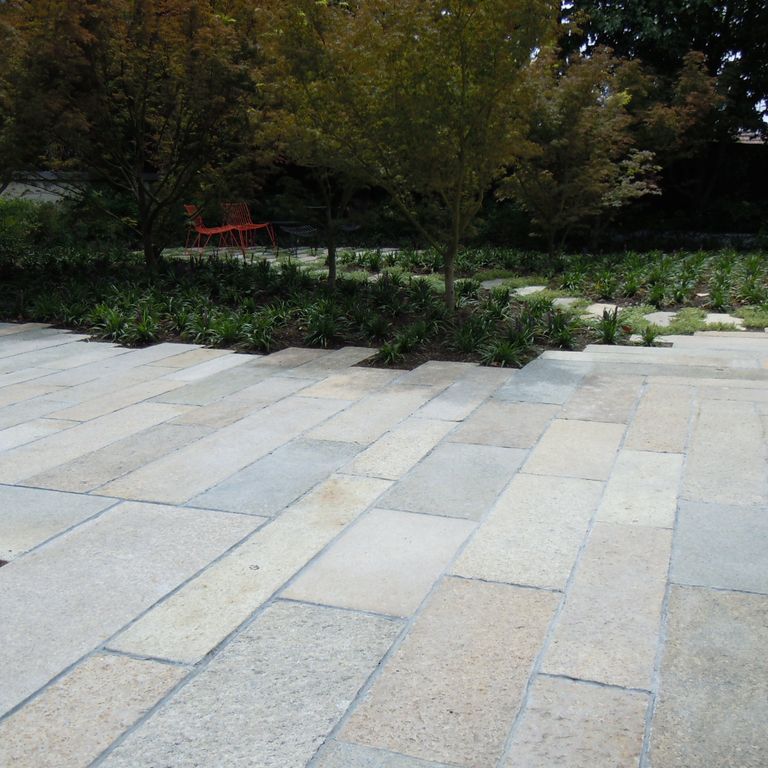 The image shows this product being used in a patio pavers application.