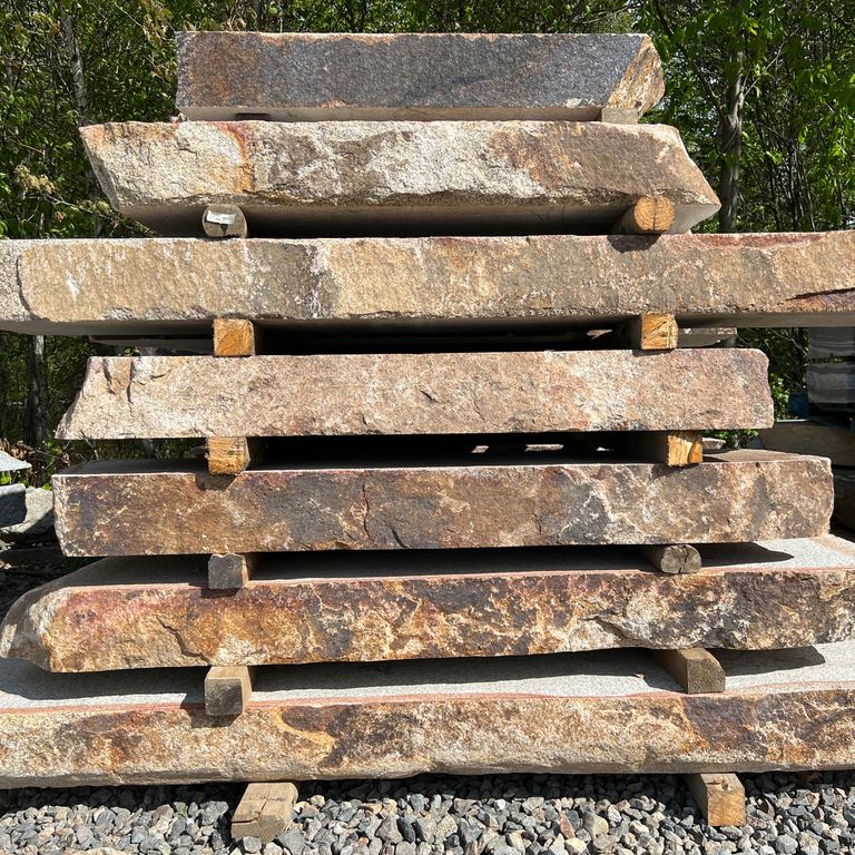 Application image for Granite - Cape Neddick Full Color - Live Edge Steps - Flamed Tops. The surface finish shown is natural. Dominant colors shown are beige, brown and tan; with black, gray, orange/rust and cream secondaries. The color mix creates a warm feeling. Blotched color pattern.