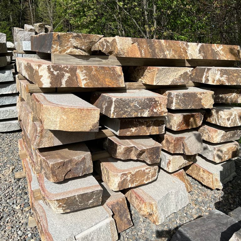 Application image for Granite - Cape Neddick Full Color - Live Edge Steps - Flamed Tops. The surface finish shown is a combination of flamed and natural. Dominant colors shown are beige and tan; with brown, gray, orange/rust, pink, white and cream secondaries. The color mix creates a warm feeling. Speckled and blotched color patterns.