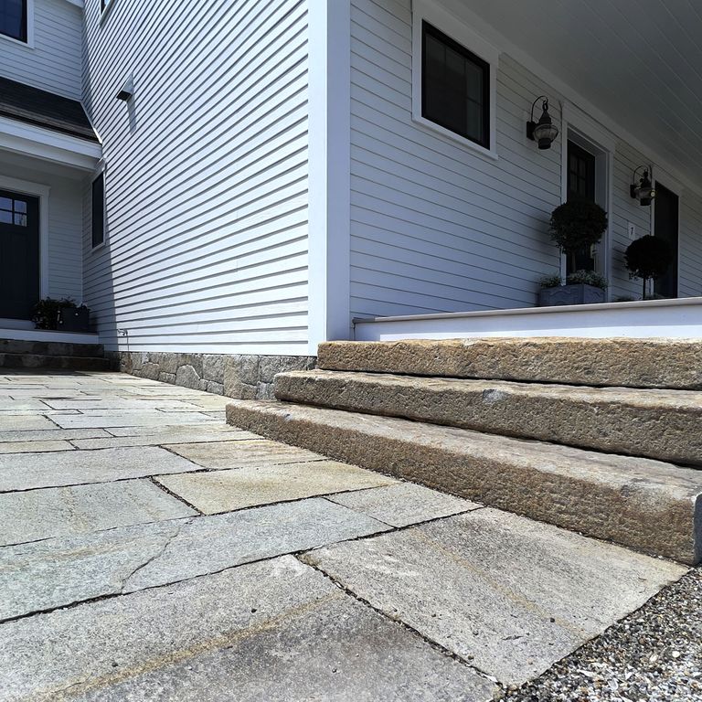 Application image for Pietra Italia Full Color Gneiss - Pavers. The image shows this product being used in a path pavers application. The surface finish shown is natural cleft. Dominant colors shown are beige and gray. The color mix creates a cool feeling. Regular, fine speckled and random color patterns.