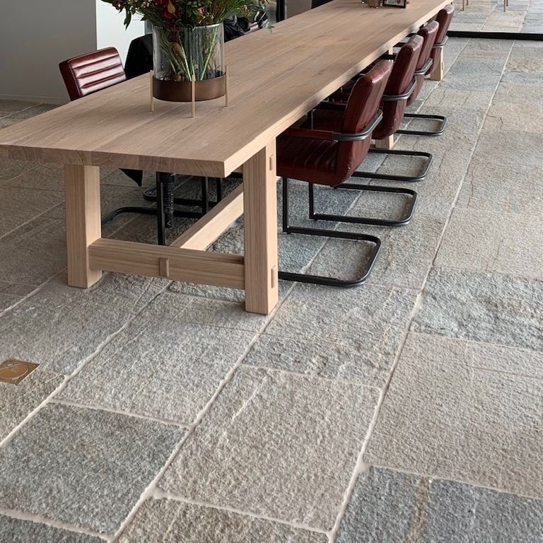Application image for Pietra Italia Full Color Gneiss - Natural Cleft & Brushed Interior Floor. The image shows this product being used in an interior floor application. The surface finish shown is natural cleft. Dominant colors shown are beige and gray. The color mix creates a warm feeling.