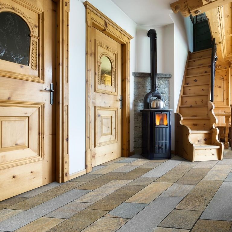 Application image for Pietra Italia Full Color Gneiss - Natural Cleft & Brushed Interior Floor. The image shows this product being used in an interior floor application. Dominant colors shown are gray and tan. The color mix creates a warm feeling.