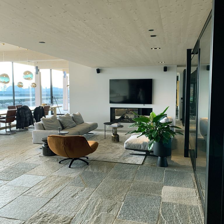 Application image for Pietra Italia Full Color Gneiss - Natural Cleft & Brushed Interior Floor. The image shows this product being used in an interior floor application. Dominant colors shown are gray and tan. The color mix creates a warm feeling.