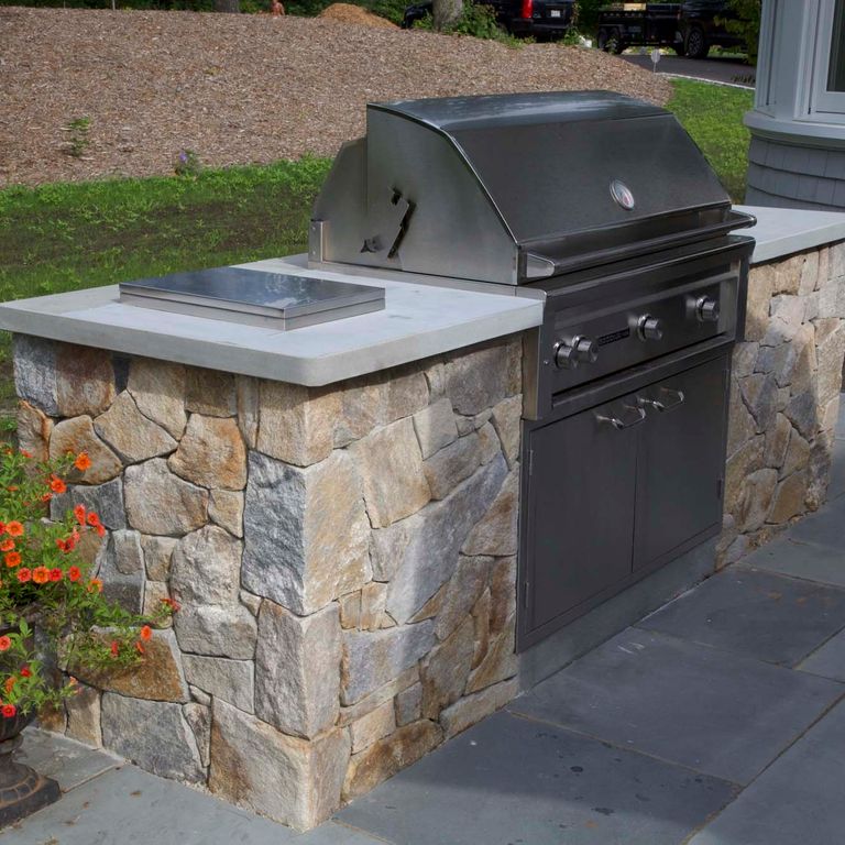 Application image for Black Mountain Granite Natural - Veneer. The image shows this product being used in a thin veneer application. The surface finish shown is natural cleft. Dominant colors shown are brown and gray. The color mix creates a warm feeling.