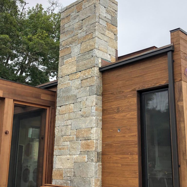 Application image for Reclaimed Granite Curbstone - Full Bed Veneer. The image shows this product being used in a full bed veneer application. Dominant colors shown are beige, brown and tan. The color mix creates a warm feeling.