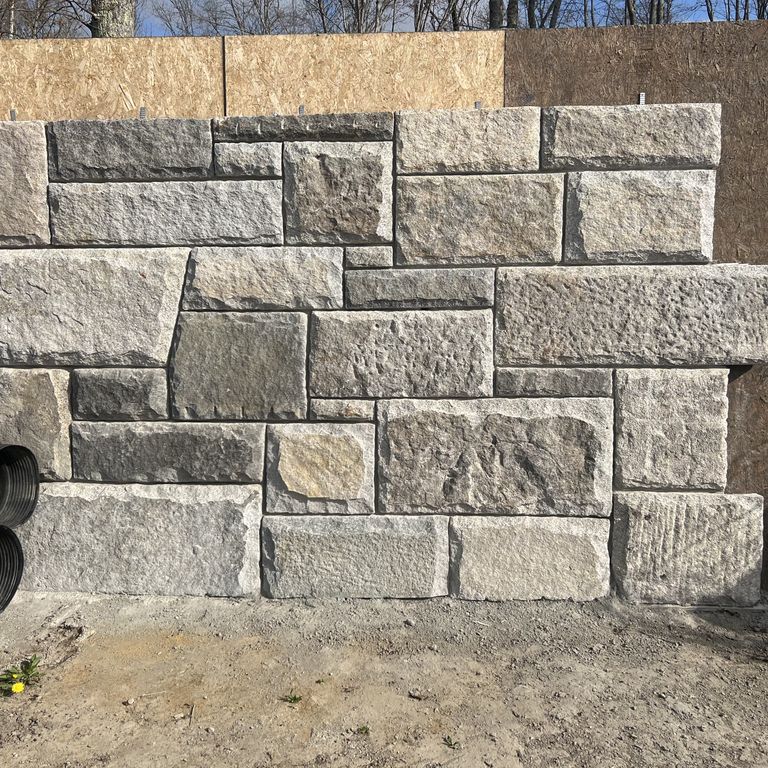 Application image for Granite - Reclaimed Curbstone - Full Bed Veneer. The image shows this product being used in a full bed veneer application. The surface finish shown is . The dominant color shown is gray.