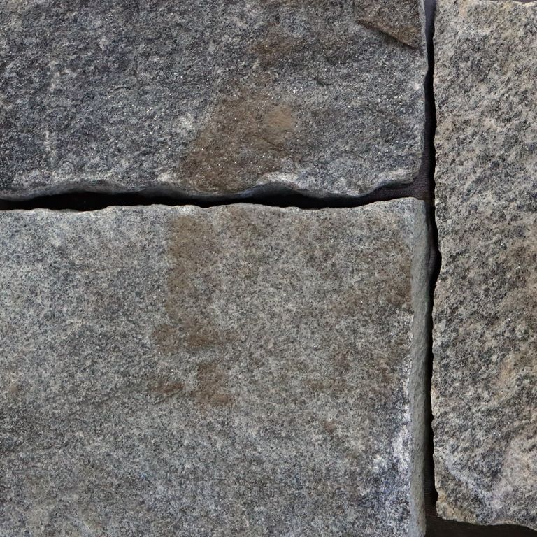 Best close-up image for Chester Granite - Veneer - Bed/Seam Splitface. The image shows this product being used in a thin veneer application. The surface finish shown is . The dominant color shown is gray. The color mix creates a cool feeling. Regular and random color patterns.