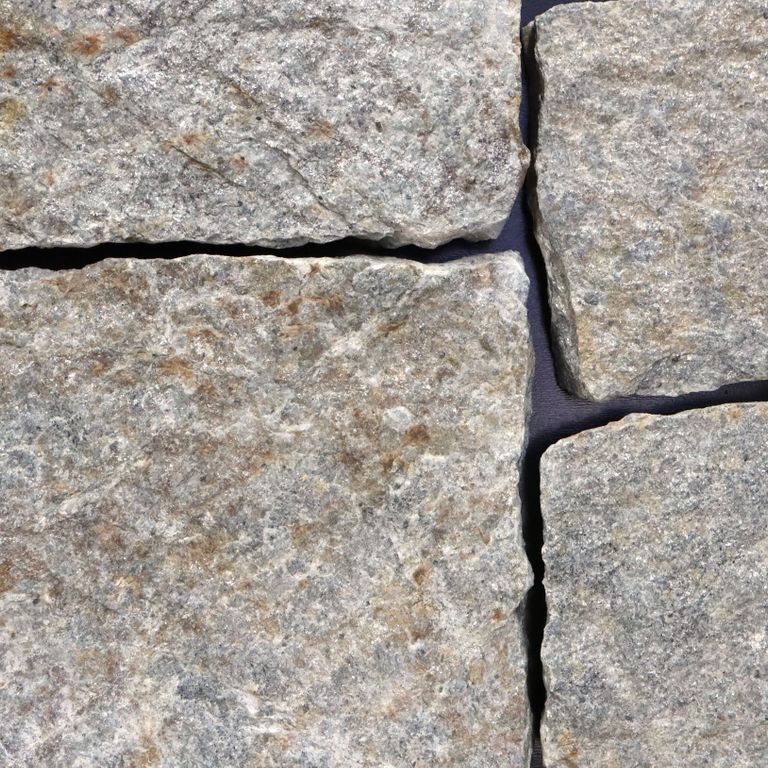 Feature image for Quaker Hill Gray Granite - Veneer - Splitface - Seam Face. The image shows this product being used in a thin veneer application. The surface finish shown is . The dominant color shown is gray. Regular and blotched color patterns.