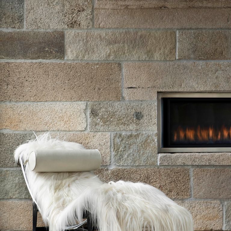 Feature image for Granite - Reclaimed Footworn - Veneer. The image shows this product being used for full bed veneer, thin veneer and interior cladding. The surface finish shown is . Dominant colors shown are gray and tan. Regular and speckled color patterns.