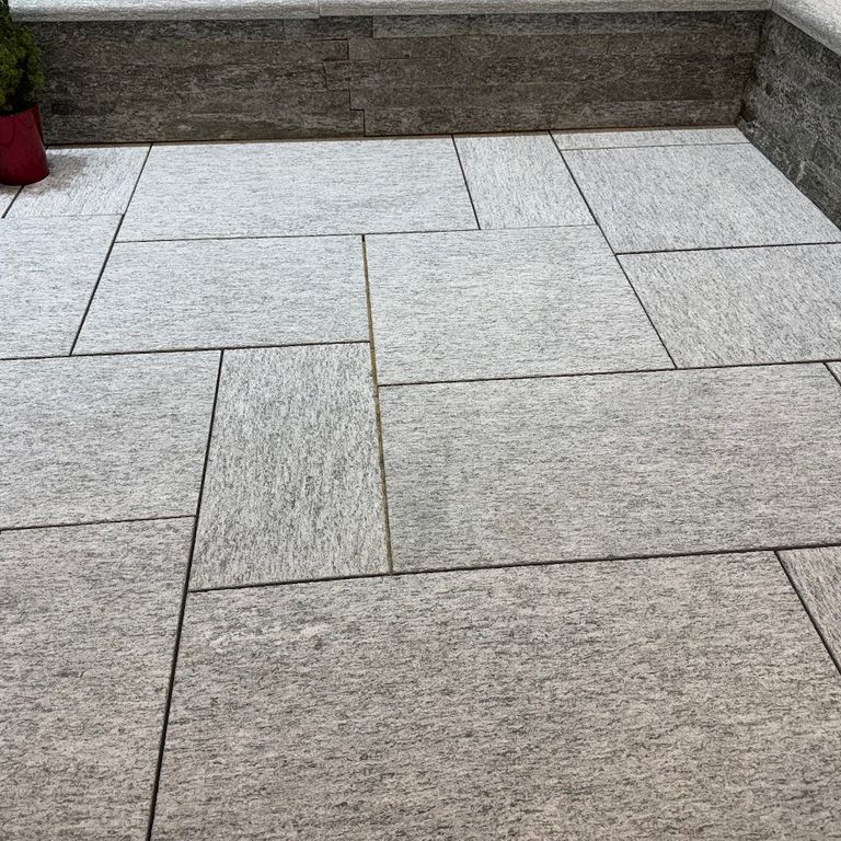 Application image for Pietra Italia Gneiss - Sawn Pavers. The image shows this product being used in a patio pavers application. The surface finish shown is sand blasted. The dominant color shown is gray.