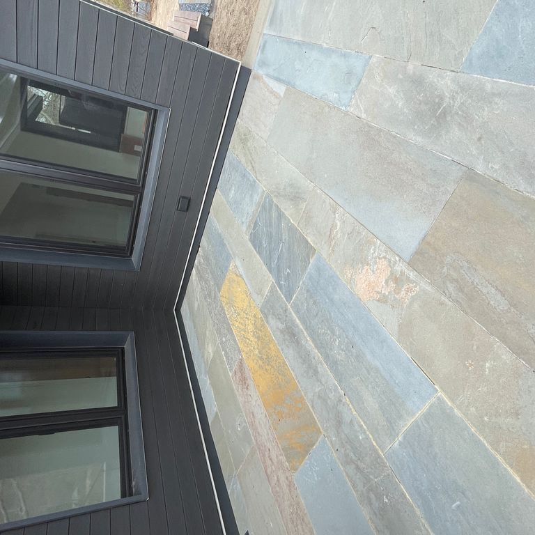 Application image for Bluestone Natural Cleft Full Color Mix - Plank Paver. The image shows this product being used in a patio pavers application. The surface finish shown is natural cleft. The dominant color shown is gray. The color mix creates a cool feeling.