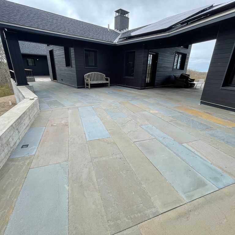 Application image for Bluestone Natural Cleft Full Color Mix - Plank Paver. The image shows this product being used in a patio pavers application. The dominant color shown is gray. The color mix creates a cool feeling.