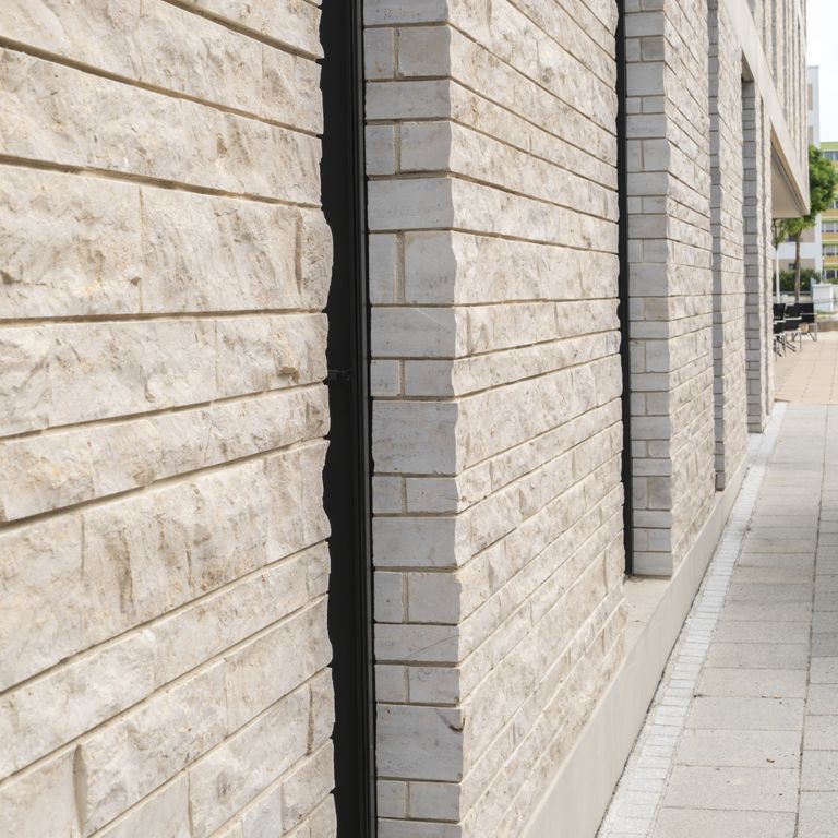 Application image for Limestone - Bavarian Beige - Bavarian Brick. The image shows this product being used in a thin veneer application. The surface finish shown is natural cleft. Dominant colors shown are beige and gray. The color mix creates a warm feeling.