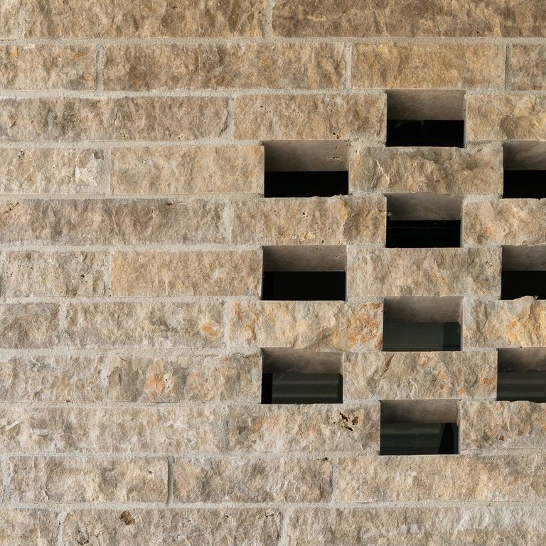 Application image for Bavarian Beige Limestone - Bavarian Brick. The image shows this product being used for full bed veneer and thin veneer. The surface finish shown is split-face. Dominant colors shown are beige and tan. The color mix creates a warm feeling.