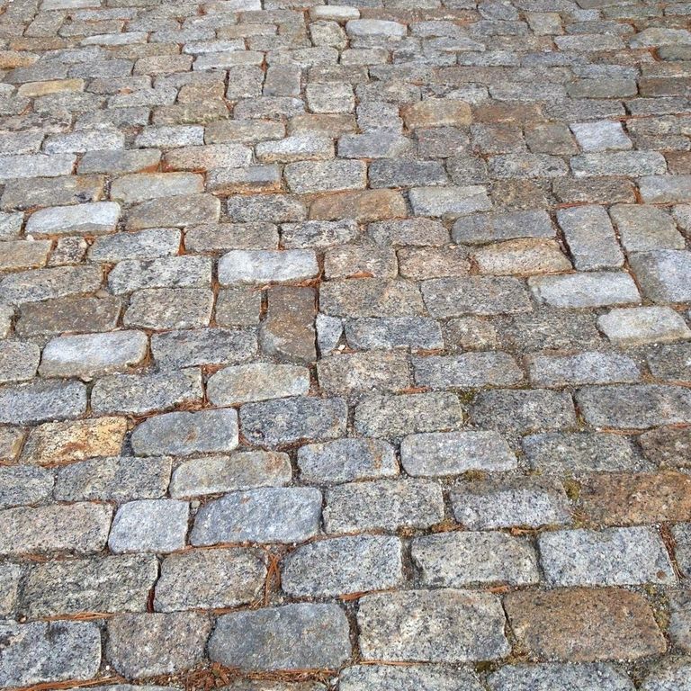 Best close-up image for Reclaimed New England Granite Cobblestone - Interior Flooring. The dominant color shown is gray.