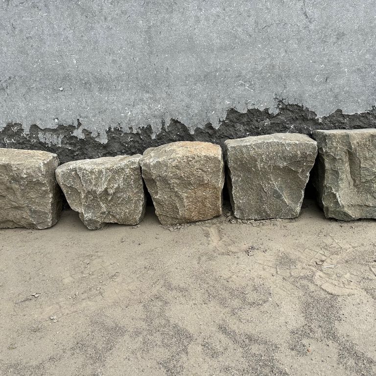 Best close-up image for Reclaimed European Porphyry Cobblestones - Edging. The surface finish shown is . The dominant color shown is gray. The color mix creates a warm feeling.