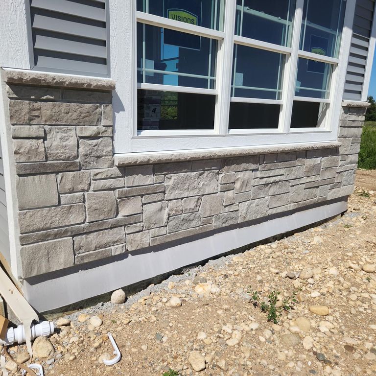 Application image for Lannon Gray Limestone Veneer - Splitface + Sawn. The image shows this product being used in a thin veneer application. The surface finish shown is split-face. The dominant color shown is gray. The color mix creates a warm feeling.