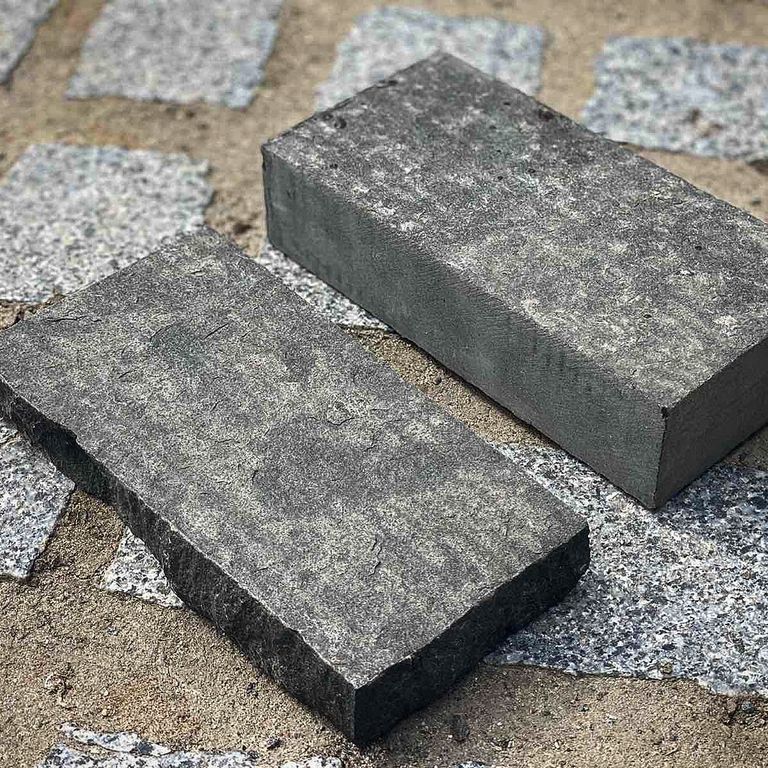 Application image for Basalt - Black Moon - Cobblestone. The image shows this product being used in a patio pavers application. The dominant color shown is gray.