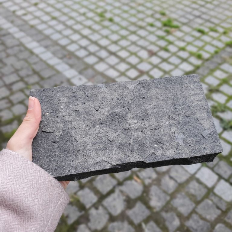 Application image for Basalt - Black Moon - Cobblestone. The image shows this product being used in a patio pavers application. The dominant color shown is gray.