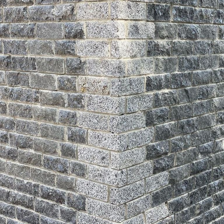 Best close-up image for Granite - White House - Veneer. The image shows this product being used in a thin veneer application. Dominant colors shown are gray and white. The color mix creates a cool feeling.