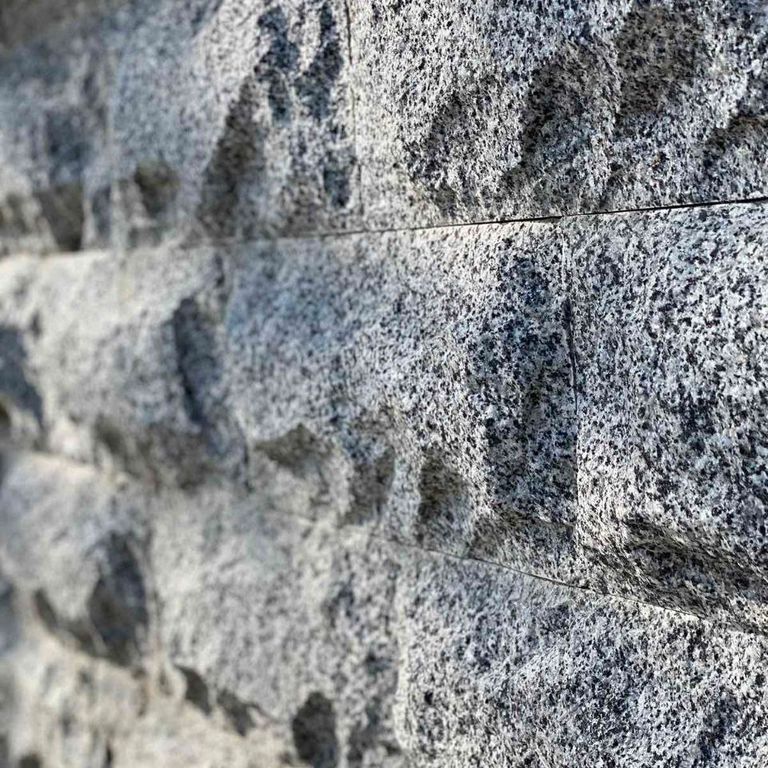 Feature image for Granite - White House - Veneer. The image shows this product being used in a thin veneer application. Dominant colors shown are gray and white. The color mix creates a cool feeling.