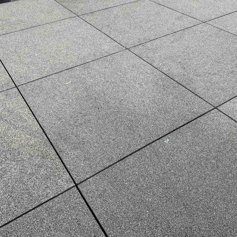 Application image for Gabbro - Dark Magma - Pavers. The image shows this product being used in a patio pavers application. The dominant color shown is gray. The color mix creates a cool feeling.