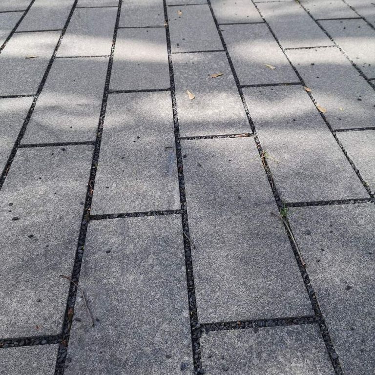 Application image for Gabbro - Dark Magma - Pavers. The image shows this product being used in a patio pavers application. The dominant color shown is gray. The color mix creates a warm feeling.