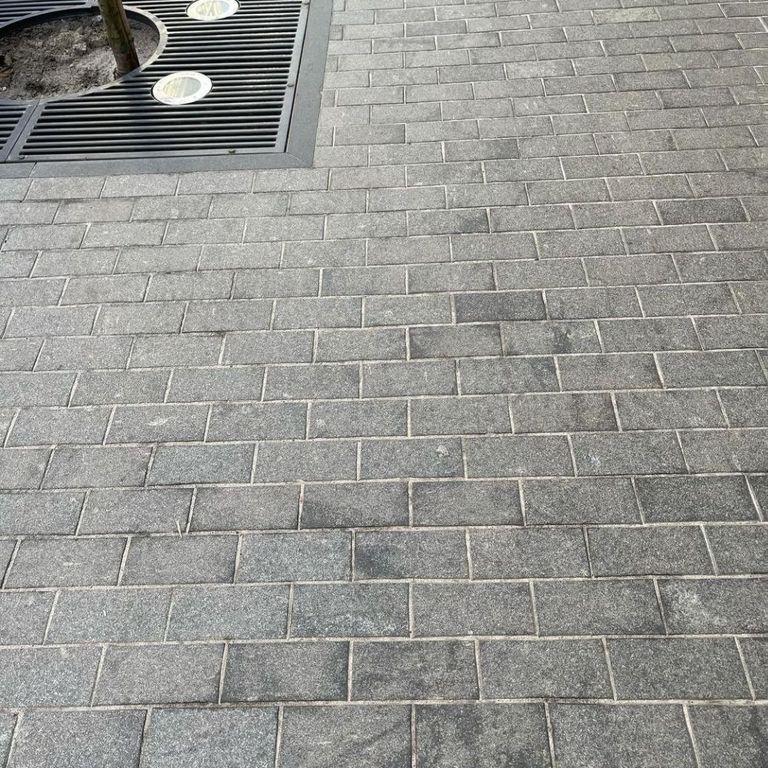 Application image for Gabbro - Dark Magma - Pavers. The image shows this product being used in a path pavers application. The dominant color shown is gray. The color mix creates a cool feeling.