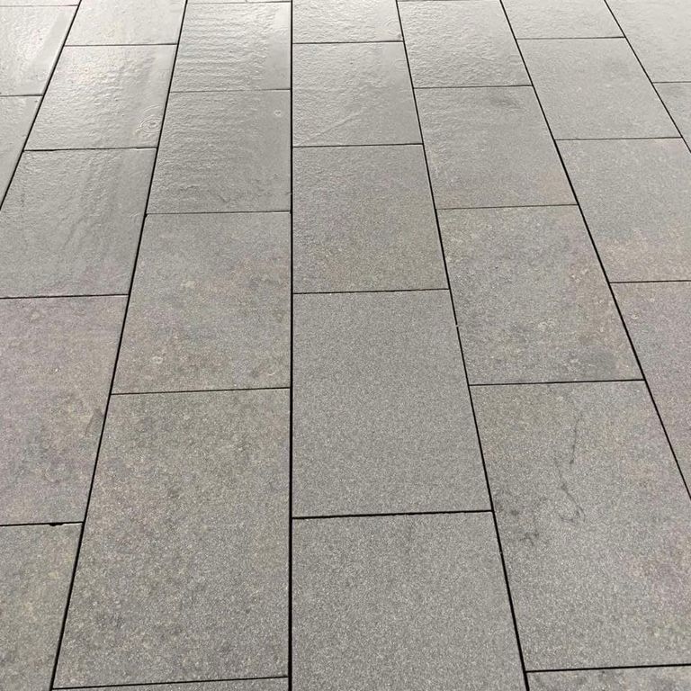 Application image for Gabbro - Dark Magma - Pavers. The image shows this product being used in a path pavers application. The dominant color shown is gray. The color mix creates a cool feeling.