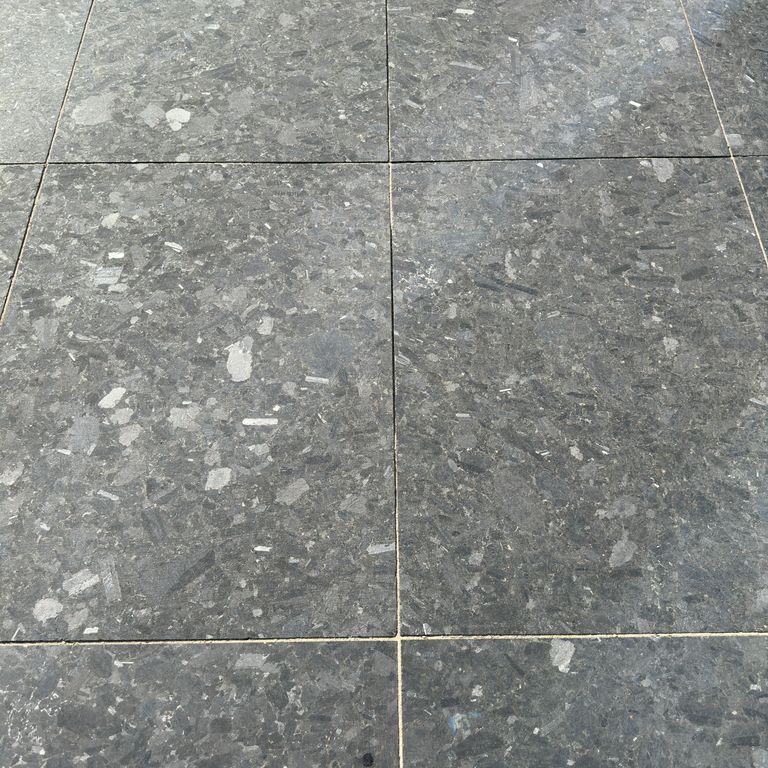 Application image for Granite - Labradorite - Blue Seven Oceans - Pavers. The image shows this product being used for driveway pavers, path pavers and patio pavers. The surface finish shown is honed. The dominant color shown is gray. The color mix creates a cool feeling.