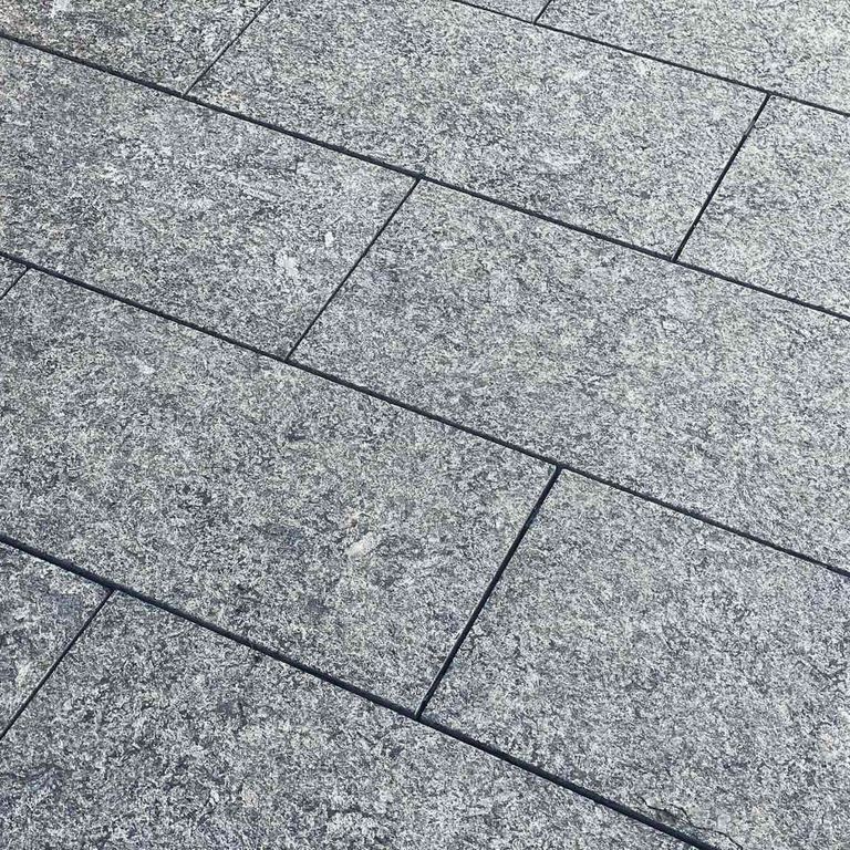 Application image for Labradorite - Blue Seven Oceans - Pavers. The image shows this product being used in a patio pavers application. The dominant color shown is gray. The color mix creates a cool feeling.