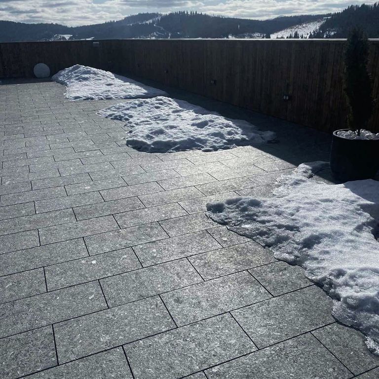 Application image for Labradorite - Blue Seven Oceans - Pavers. The image shows this product being used in a patio pavers application. The dominant color shown is gray. The color mix creates a cool feeling.