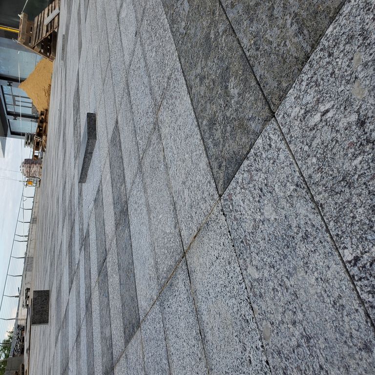 Application image for Granite - Gray Leopard - Pavers. The image shows this product being used in a patio pavers application. The dominant color shown is gray. The color mix creates a cool feeling. Coarse speckled color pattern.