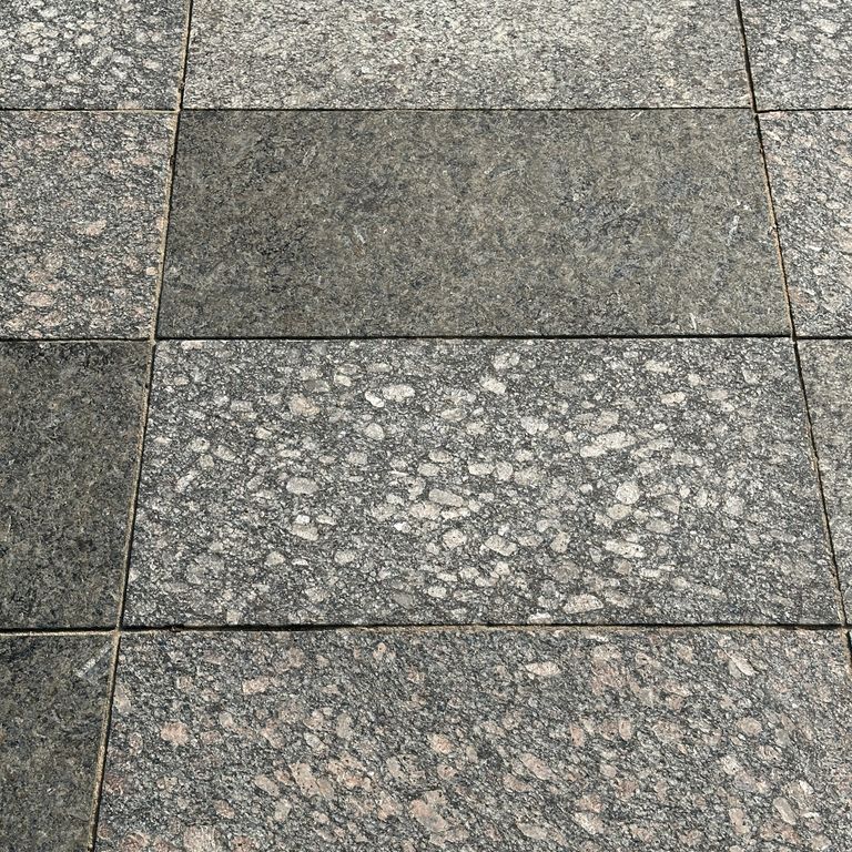 Application image for Granite - Gray Leopard. The image shows this material being used for driveway pavers, path pavers, patio pavers and driveway aprons. The dominant color shown is gray. The color mix creates a warm feeling.