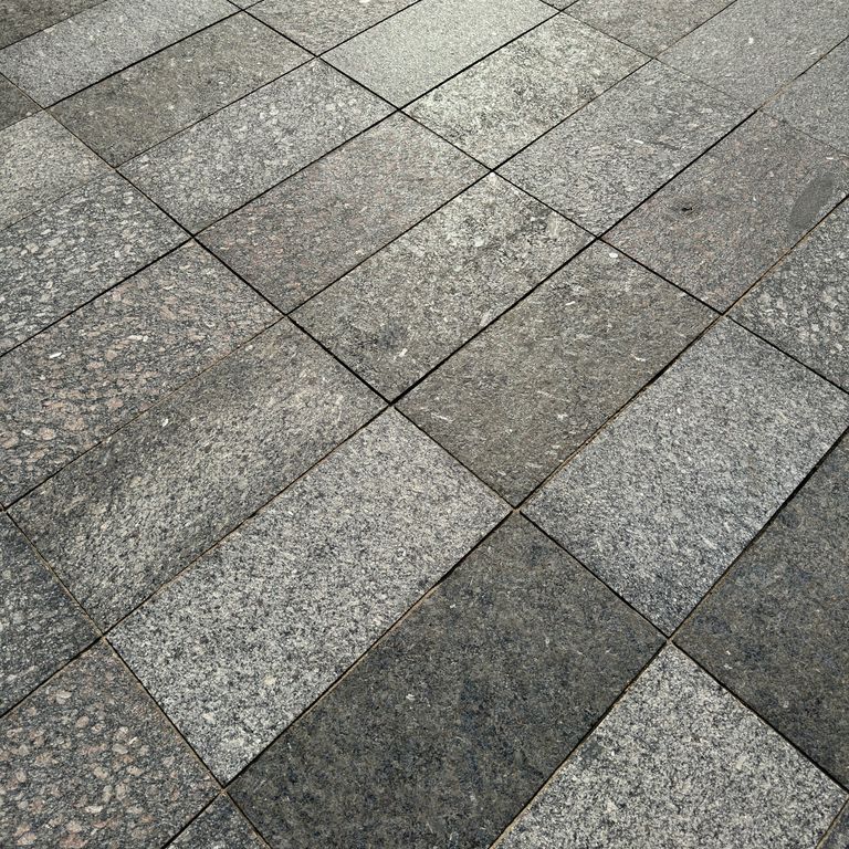 Application image for Granite - Gray Leopard - Pavers. The image shows this product being used for driveway pavers, path pavers and patio pavers. The dominant color shown is gray. The color mix creates a warm feeling.