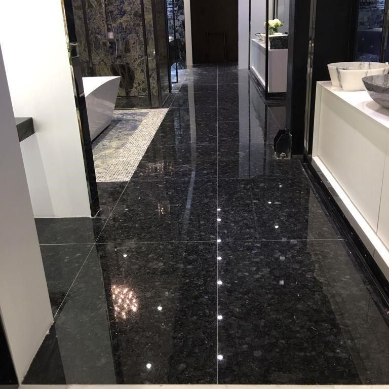 Application image for Labradorite - Blue Seven Oceans - Interior Tiles. The image shows this product being used in an interior floor application. The dominant color shown is black. The color mix creates a cool feeling.