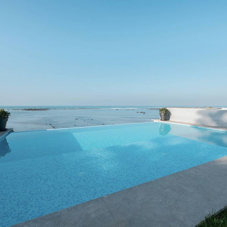Application image for Limestone - Casablanca - Pool Coping. The image shows this product being used in a pool coping application. The dominant color shown is gray. The color mix creates a cool feeling.