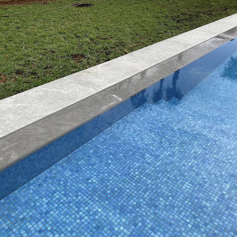 Application image for Limestone - Casablanca - Pool Coping. The image shows this product being used in a pool coping application. The dominant color shown is gray. The color mix creates a cool feeling.