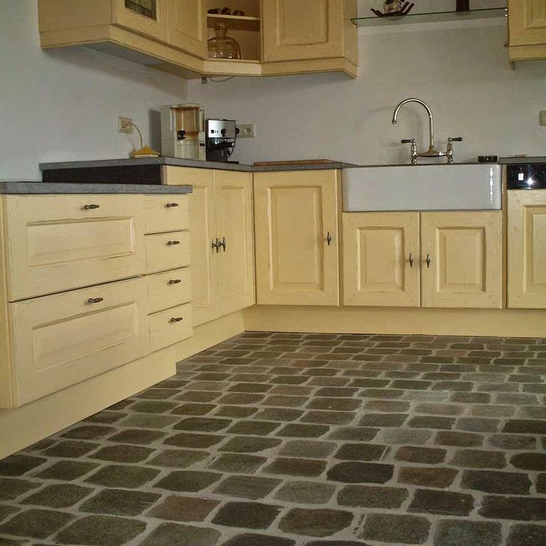Application image for Porphyry - Reclaimed European Cobblestone - Rectangle - Flat Surface. The image shows this product being used in an interior floor application. The surface finish shown is sawn. The dominant color shown is brown. The color mix creates a warm feeling.