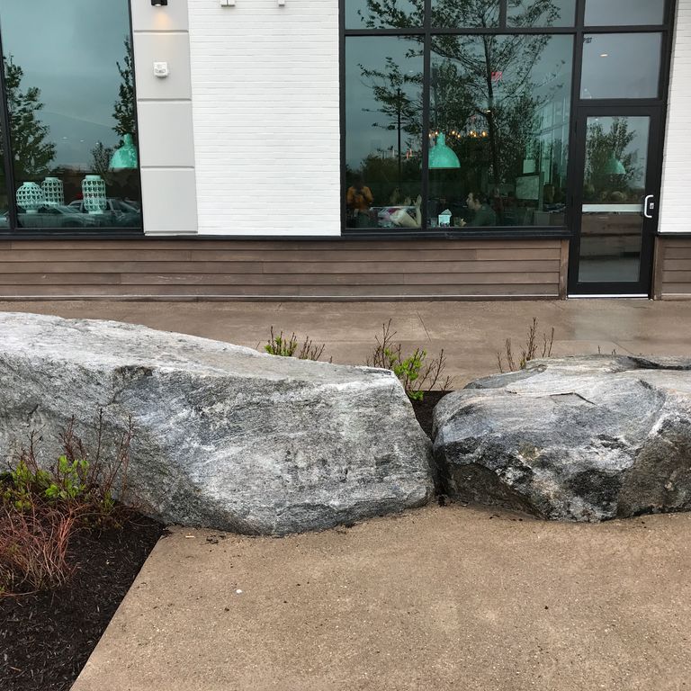 Application image for New England Fieldstone Boulders & Ledgestone - Seating & Benches. The image shows this product being used in a seating & benches application. The surface finish shown is weathered. The dominant color shown is gray. The color mix creates a warm feeling.