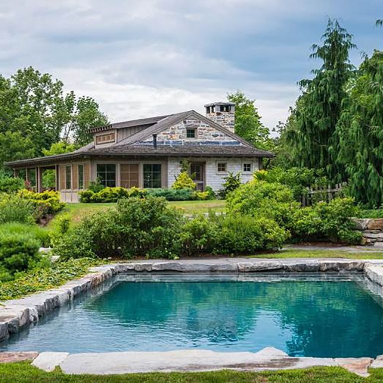 Application image for Fieldstone - New England Boulders - Pool/Pond Coping. The image shows this product being used for pond border coping and pool coping. The surface finish shown is weathered. The dominant color shown is gray.