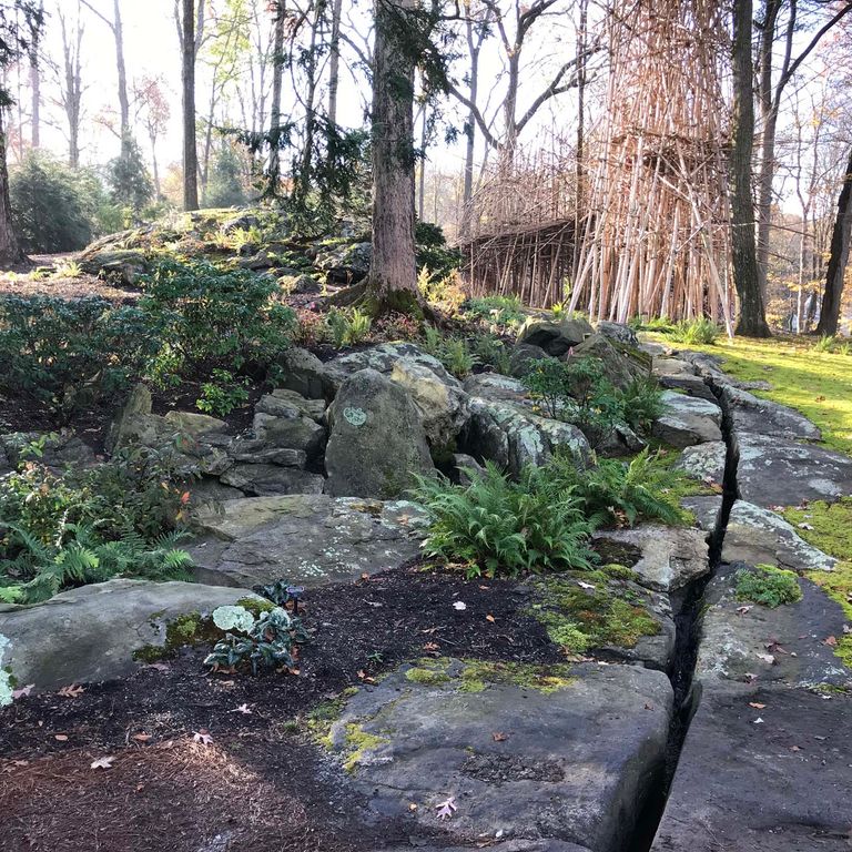 Application image for New England Fieldstone Boulders & Ledgestone - Pool/Pond Coping. The image shows this product being used for water features and landscape boulders & ledge. The surface finish shown is weathered. The dominant color shown is gray. The color mix creates a cool feeling.